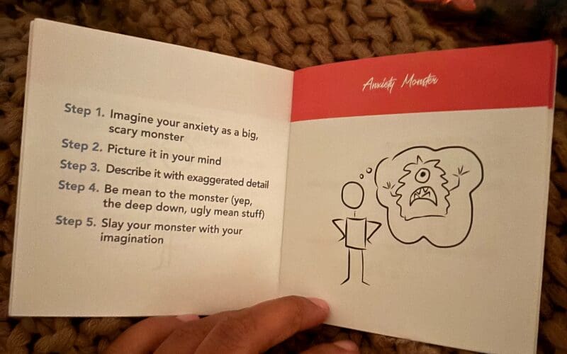 An open page from the booklet showing the “Anxiety Monster” exercise with stick-figure illustrations.